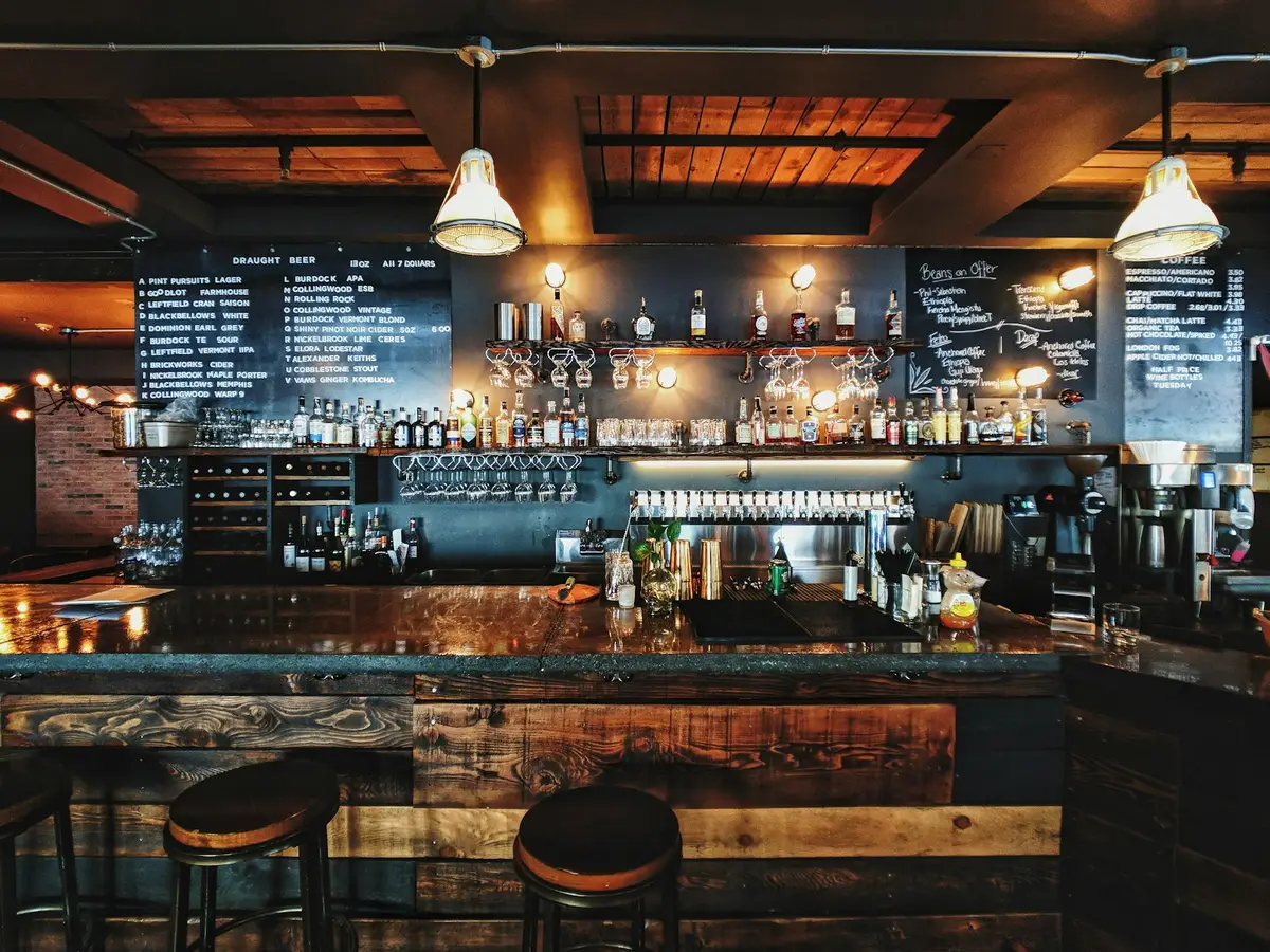 The bar at The Copper Kettle, bottles and glassware under warm pendant lamps