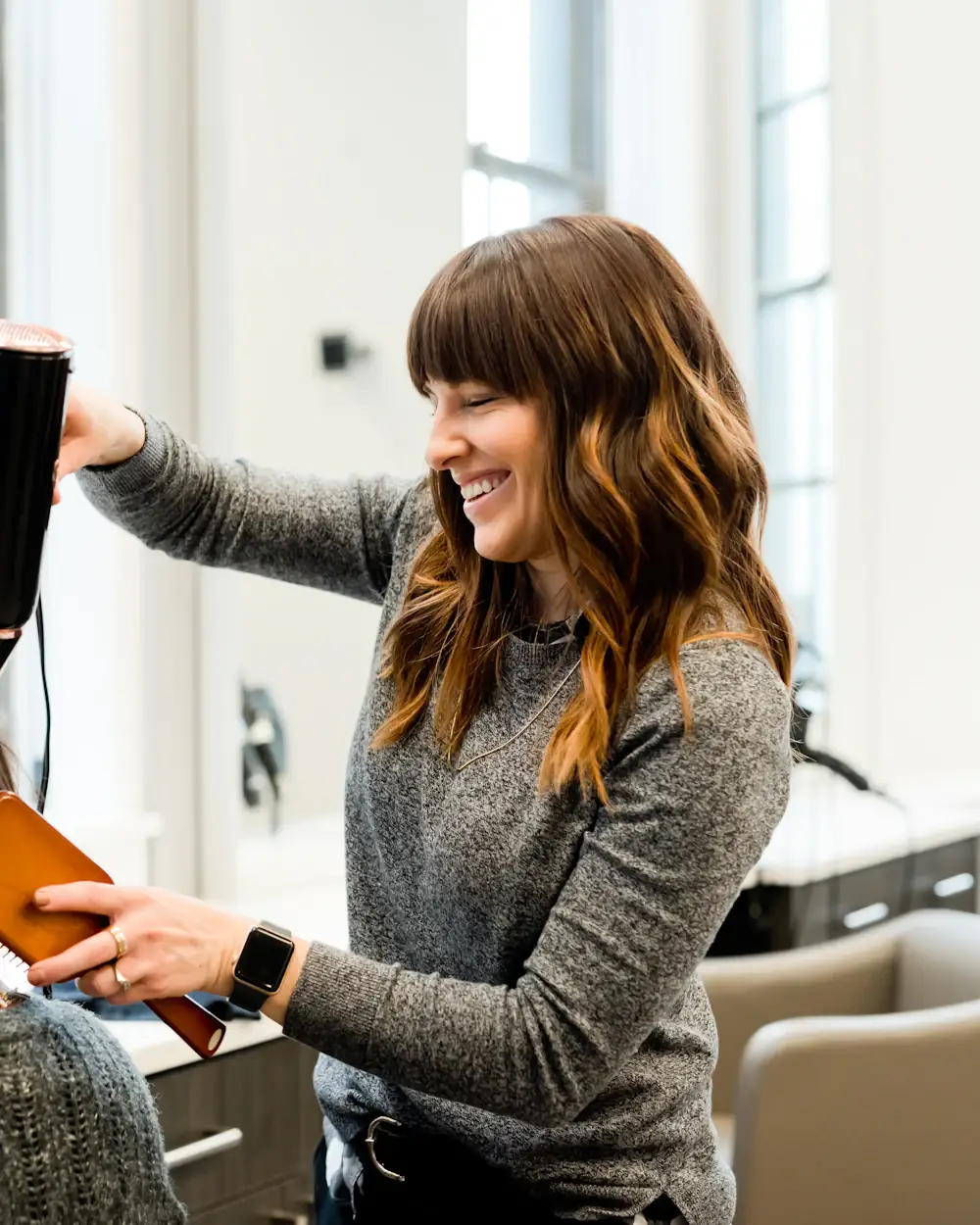 Stylist finishing a blowout at Marlowe & Main